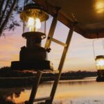 camping lantern glowing on table at campsite に関連するアウトドア写真